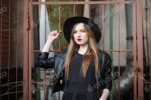 Preview: A Girl Walks Down The City Street In A Leather Waistcoat With A Phone. Young Beautiful Girl In A