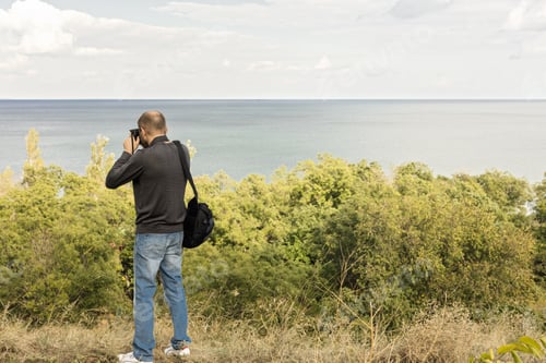 Preview: Beautiful Sea Landscape. A Man Photographs The Sea And The Sky. Selective Focus.