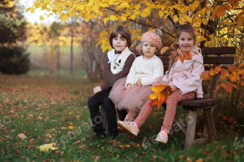 Preview: Young Family On A Walk In The Autumn Park On Sunny Day. Happiness To Be Together.