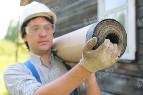 Preview: A Man In The Form Of A Builder Repairs A House