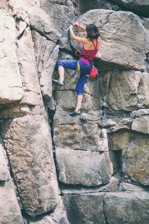 Preview: The Girl Climbs The Rock. Rock Climber Is Training On Natural Terrain. Extreme Hobby. A Woman