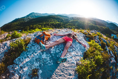 Preview: A Girl With Backpack Lies On Top Of A Mountain At Sunset. A Woman Is Engaged In Yoga. Meditation Is