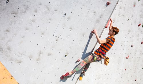Preview: A Young Woman With Short Hair Climbs On The Climbing Wall.