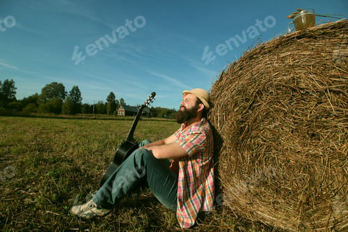 Preview: Man With Guitar And Beer On The Nature