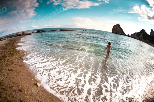 Preview: The Girl Goes Into The Sea Water. Woman Bathes In The Ocean. Rest On The Coast. Slender Brunette In