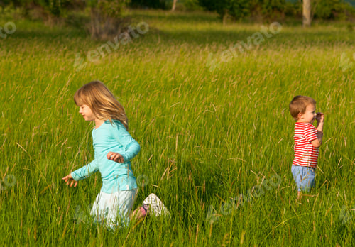 Preview: Brother And Sister Playing On The Meadow On Sunny Summer Day.