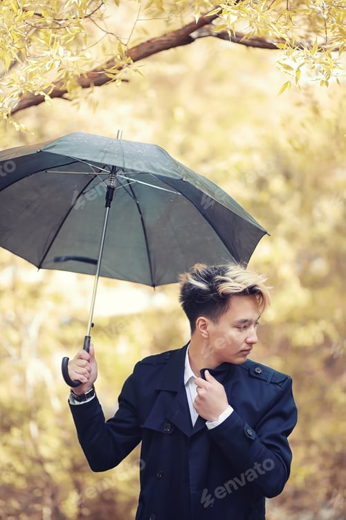 Preview: Autumn Park In Rainy Weather And A Young Man With An Umbrella