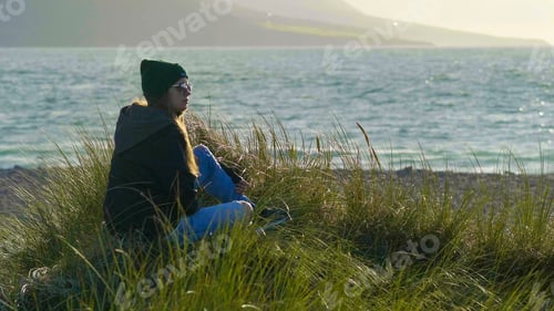 Preview: Pretty Girl Rests In The Reed Grass Near The Ocean