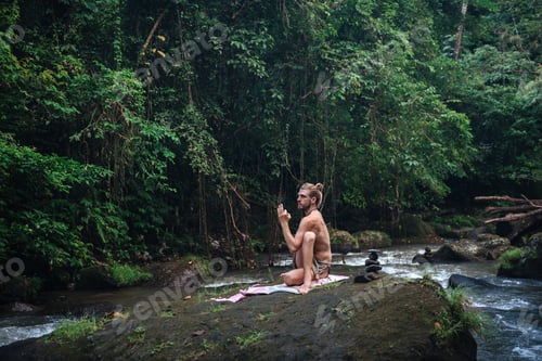 Preview: Yoga Practice And Meditation In Nature. Man Practicing Near River.