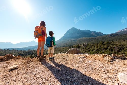 Preview: The Boy And His Mother Are Standing On The Top Of The Mountain. A Woman Is Traveling With Child