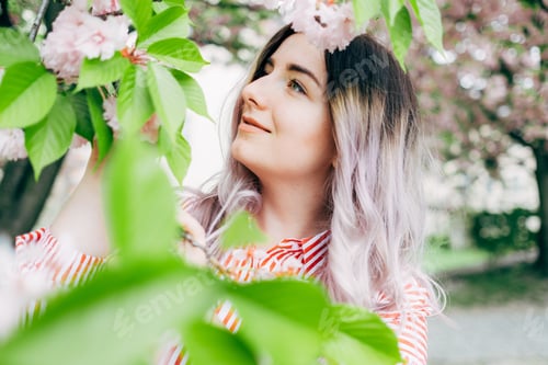 Preview: Beautiful Young Woman Enjoying Sunny Day In Park During Cherry Blossom Season