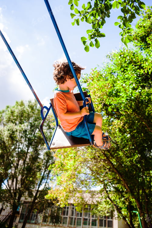 Preview: The Boy Is Riding On A Swing In The Amusement Park, A Happy Childhood.