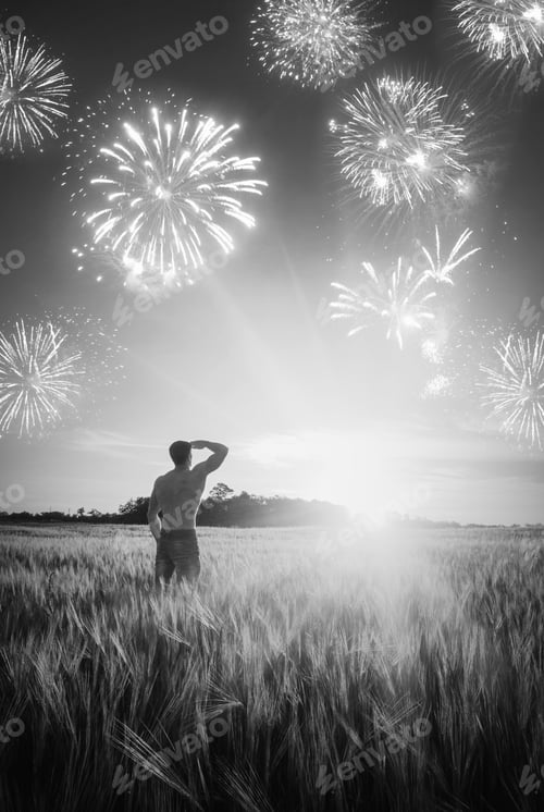 Preview: Man Who Enjoy Holiday Firework In A Wheat Field At Sunset Light. Black And White