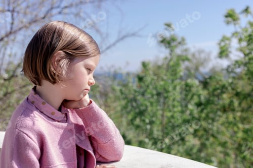 Preview: Little Cute Girl (7 Years Old) Is Standing Against The Sea In A Pink Outfit. Selective Focus.