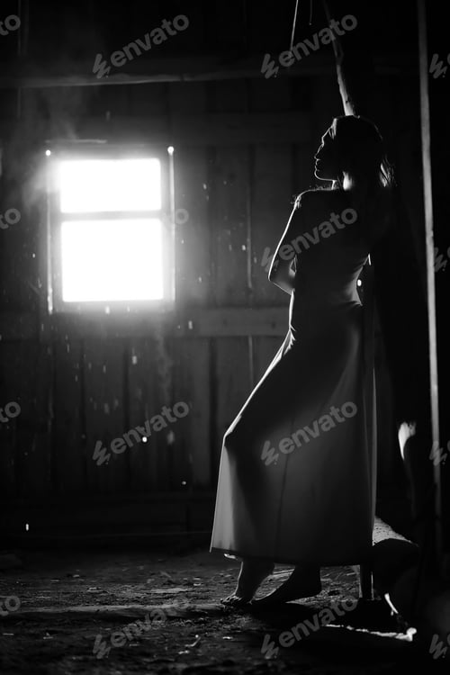 Preview: Silhouette Of A Beautiful Girl In A Dress On The Background Of A Window In An Old House