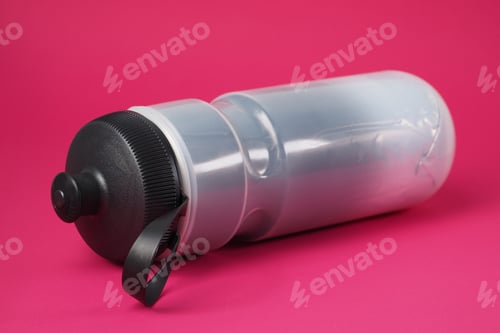 Preview: Gray Insulated Plastic Sport Bottle For Cycling Lie On Red Background.
