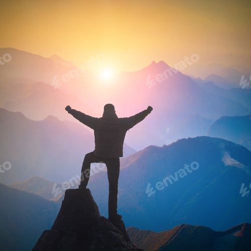 Preview: Hiker Standing On A Cliffs Edge With Raised Hands And Rejoices Sunrise In A Mountain Valley.