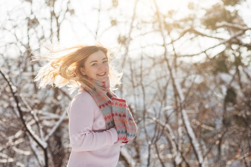 Preview: Young Caucasian Attractive Blonde Girl In Pink Sweater And Knitted Scarf Holds In Winter Park