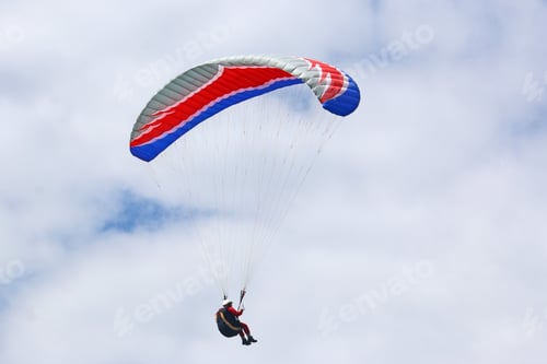 Preview: Paraglider Flying In A Cloudy Sky