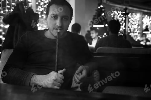 Preview: Handsome Man Holding Glass Of Alcohol With Ice In A Night Club