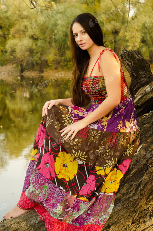 Preview: Beautiful Lady In Long Dress Sitting On The Tree On Sunny Autumn Day.