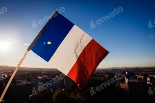 Preview: The Flag Of France On Background Of The View Of Paris From Sacre Coeur Basilica In France In Sunset