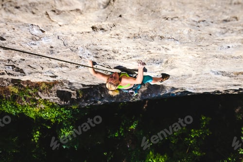 Preview: The Girl Climbs The Rock. A Woman Is Engaged In Fitness In Nature. Extreme Sport. Climbing Route