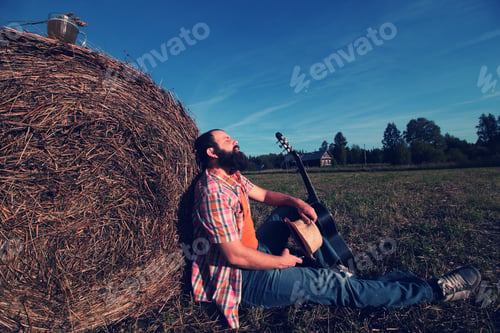Preview: Man With Guitar And Beer On The Nature