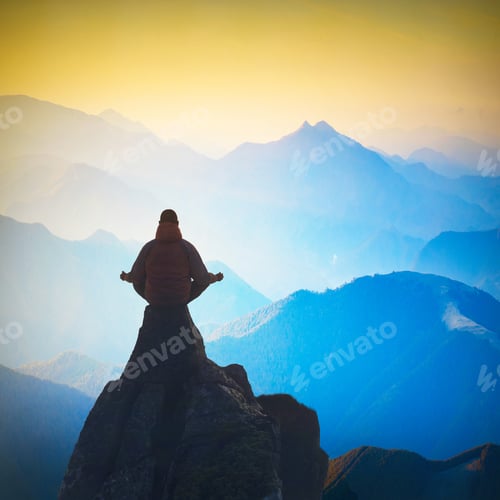 Preview: Man Meditating In Sitting Yoga Position On The Cliffs Edge Above Mountain Valley At Sunset Light