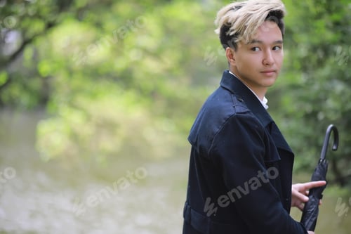 Preview: Spring Park In Rainy Weather And A Young Man With An Umbrella
