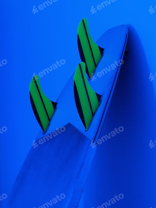 Preview: Surfboard With Fins Is At Home Near The Wall At Night. Blue Neon Lights.