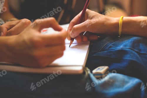 Preview: A Person Draws With A Pencil In A Notebook. Soft Focus.