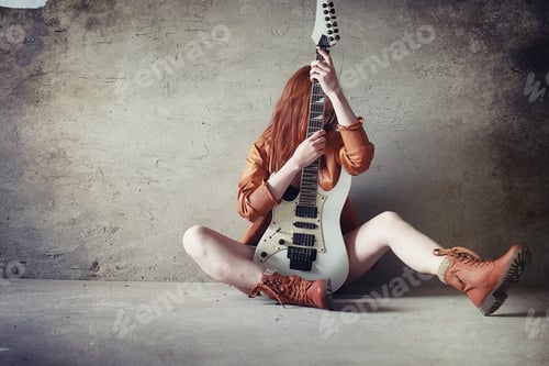 Preview: Young Red-Haired Girl With Electric Guitar. Rock Musician Girl In A Leather Jacket. She Is A Pretty