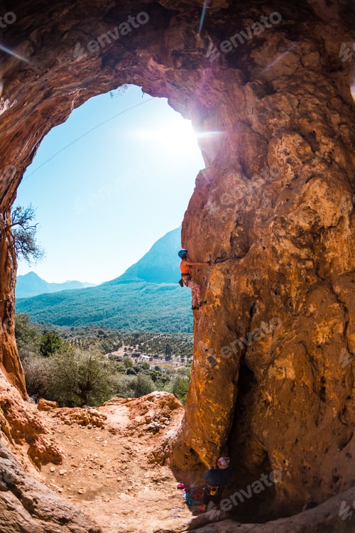 Preview: Rock Climber Climbs Into The Cave. Rock In The Form Of An Arch. The Woman Trains On A Natural