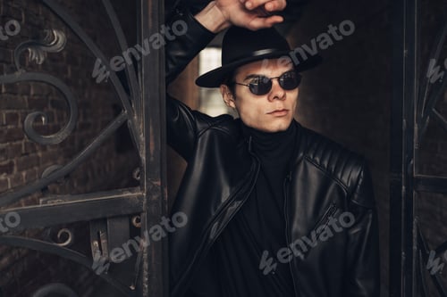 Preview: Portrait Of Stylish Young Man In Black Leather Jacket And Hat