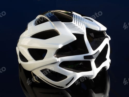 Preview: White Bicycle Helmet On A Black Table. Rear Side View.