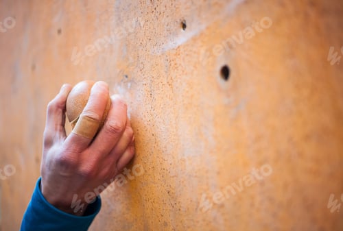 Preview: The Hand Of The Climber Clinging To A Lead On The Climbing Wall, Bandaged Finger With A Band-Aid.