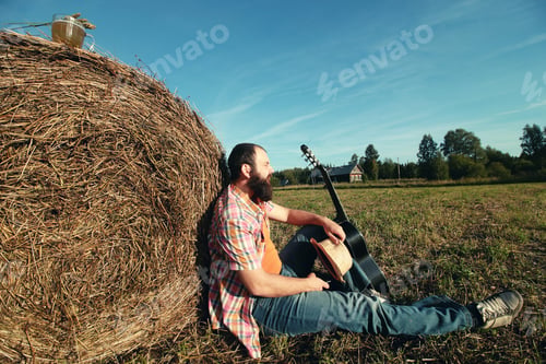 Preview: Man With Guitar And Beer On The Nature