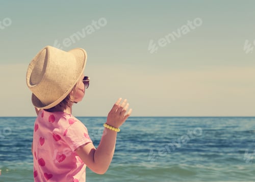 Preview: Cute Little Girl In A Straw Hat On The Beach. The Image Is Tinted.