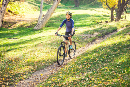 Preview: Biking In The Forest. Girl Rides A Bike On A Forest Trail. Woman Riding Her Bike In The Park