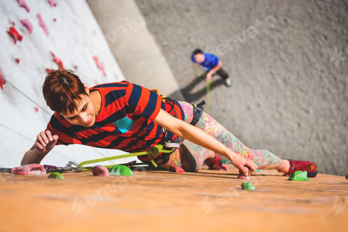 Preview: A Young Woman With Short Hair Climbs On The Climbing Wall.
