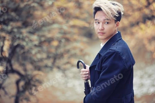 Preview: Autumn Park In Rainy Weather And A Young Man With An Umbrella