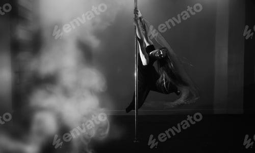 Preview: Girl Doing Exercises On A Sports Equipment. The Dancer On The Pylon In The Studio.