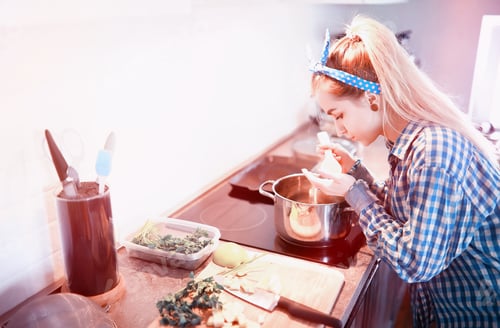 Preview: A Cute Young Girl In The Kitchen Prepares Dinner
