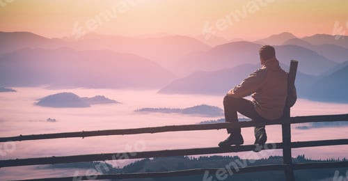 Preview: Man Sitting On A Wooden Fence And Enjoy Misty Valley In A Light Of Sunrise. Instagram Stylization.