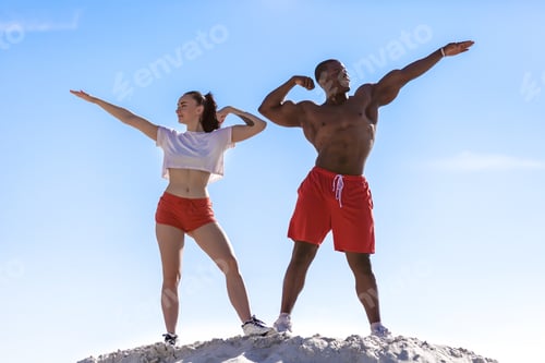 Preview: Portrait Of Young Fitness Couple African American Man Bodybuilder And Sexy Brunette Woman In