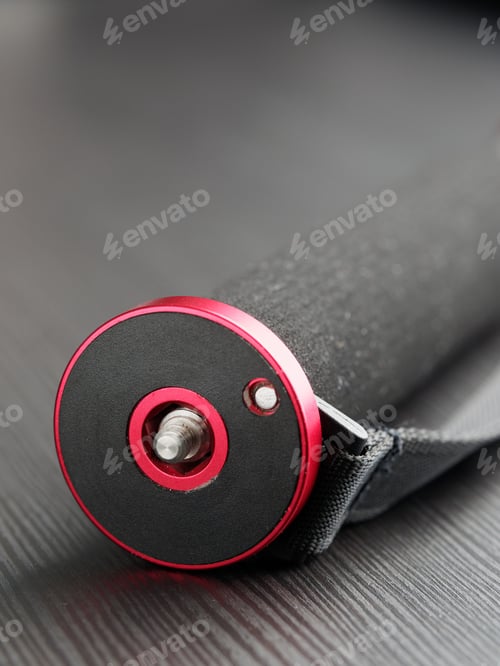 Preview: Black Modern High-Quality Monopod On A Dark Table.