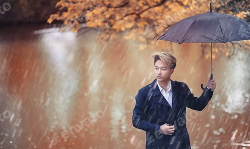 Preview: Autumn Park In Rainy Weather And A Young Man With An Umbrella