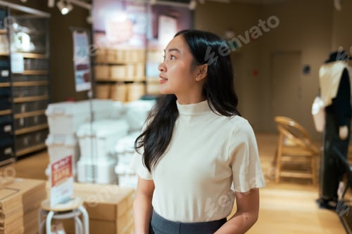 Preview: Young asian woman shopping exploring modern retail store