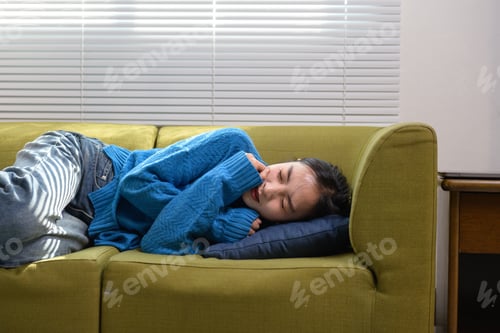 Preview: Young woman resting at home feeling comfortable